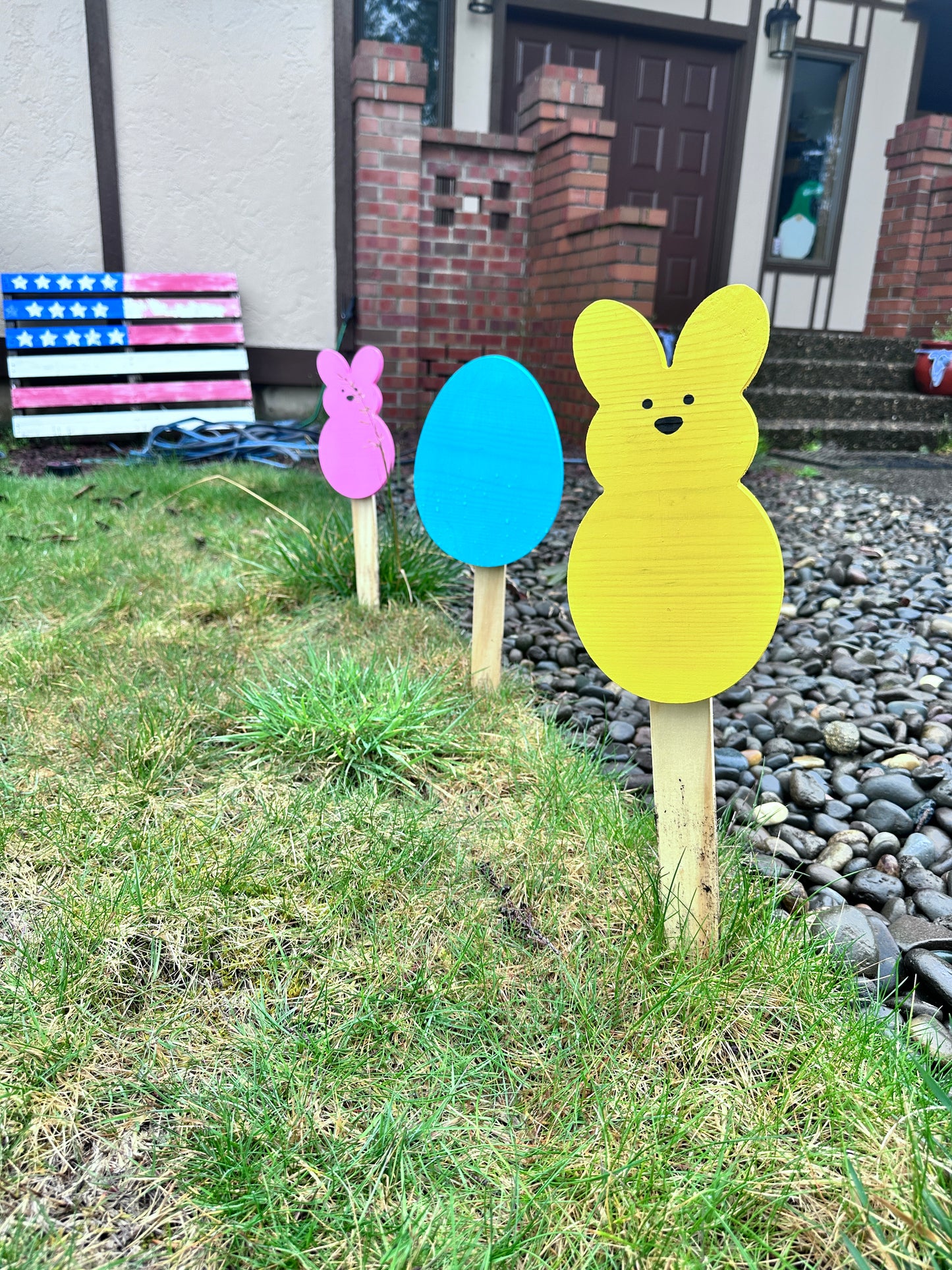 Blue Egg, Pink & Yellow Peeps Bunny 18 inch yard stakes in grass with house in background