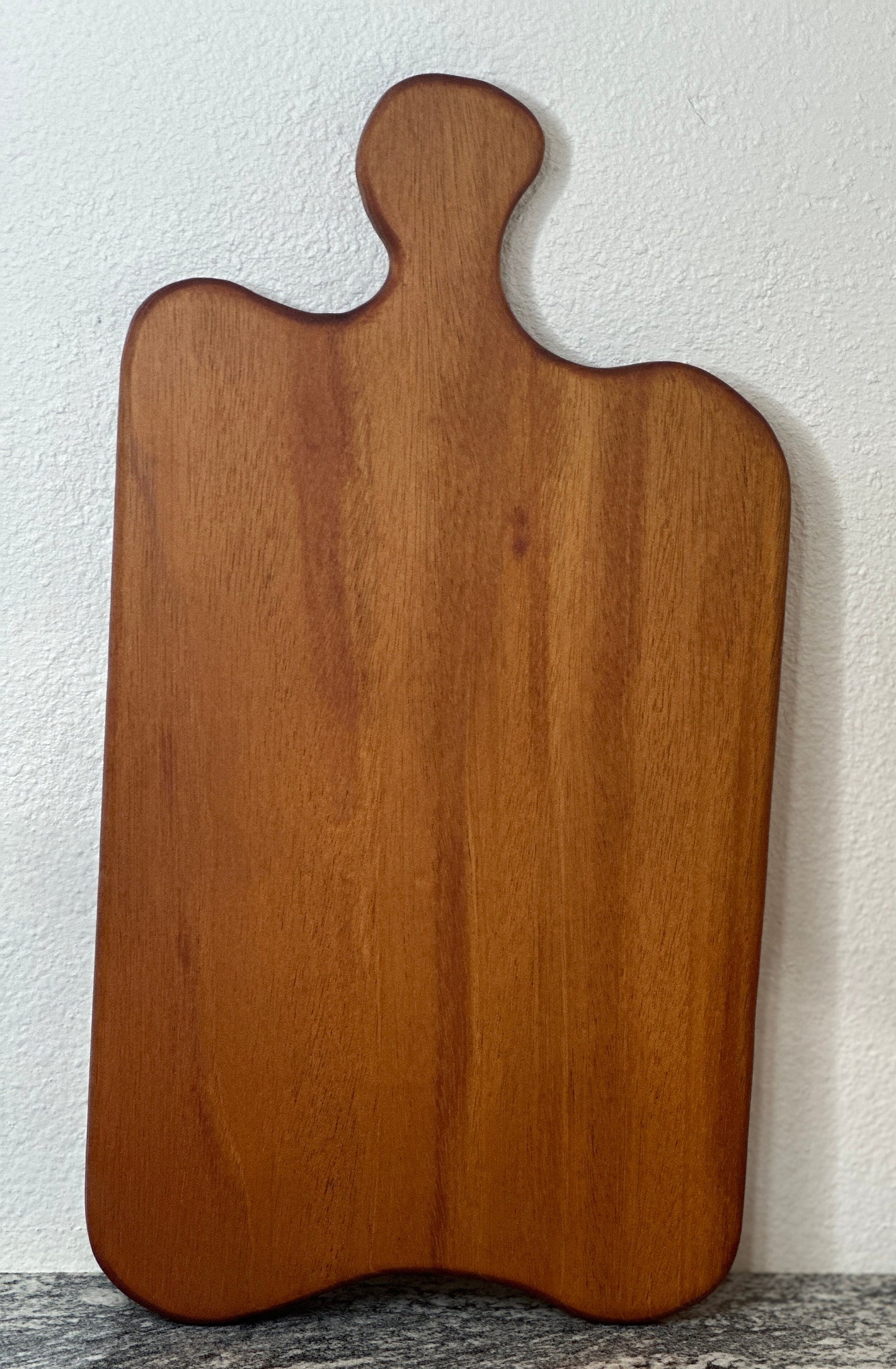 Mahogany red hardwood paddle shaped charcuterie board