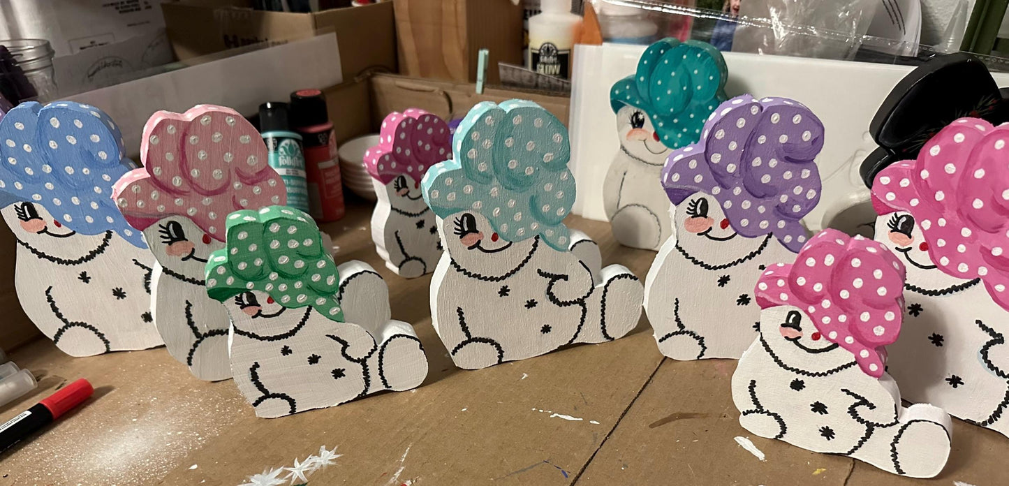 9 Wood painted snow woman shelf sitters with varies colors of painted caps