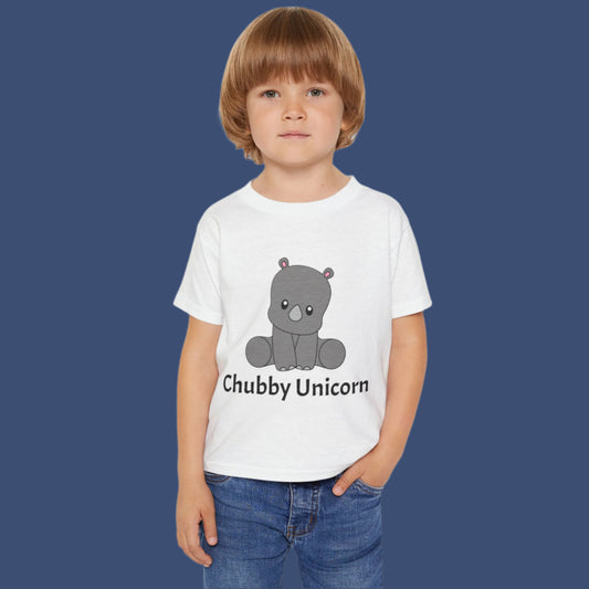 Toddler with white T-shirt with grey cute baby rhino sitting with black font text underneath that reads chubby unicorn