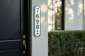 Custom 2-inch vertical HDPE address sign mounted beside a front door