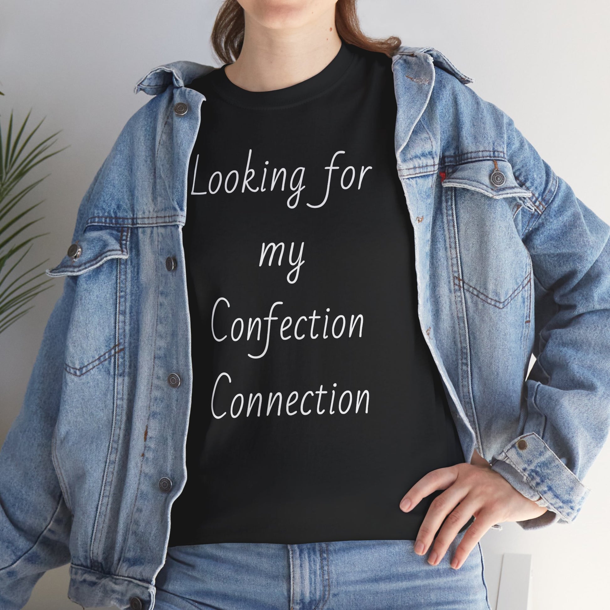 Woman in denim jacket wearing black t-shirt displaying the slogan "Looking for my Confection Connection"