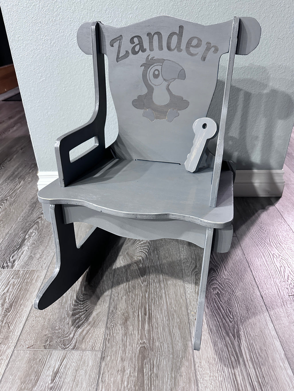 Grey stained rocking chair with Zander name and Toucan engraving