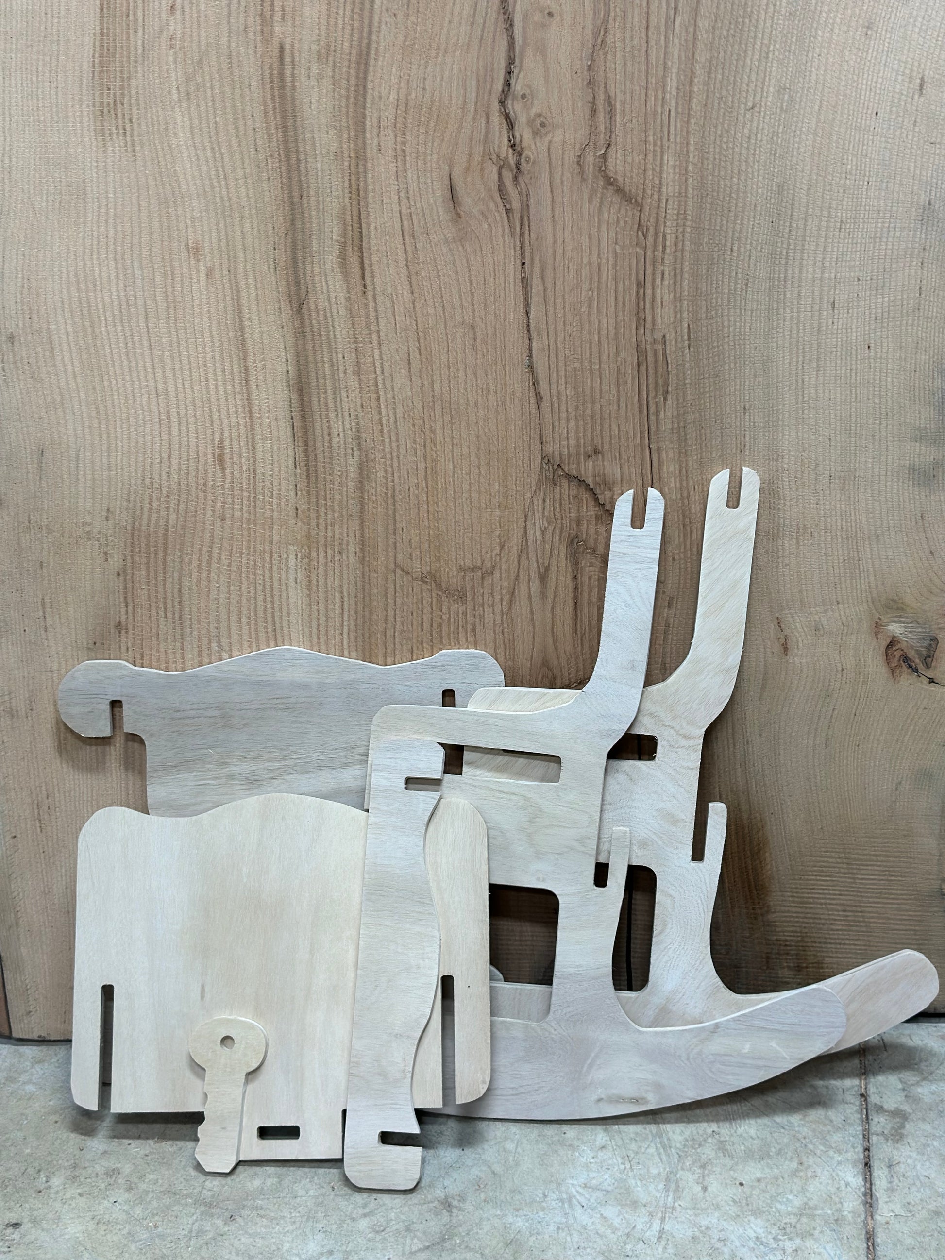 Side view of all of the rocking chair puzzle pieces that go together to complete the chair.