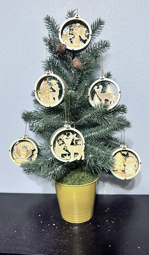 Table-top Christmas tree displaying a set of six wooden 3d Christmas ornaments.