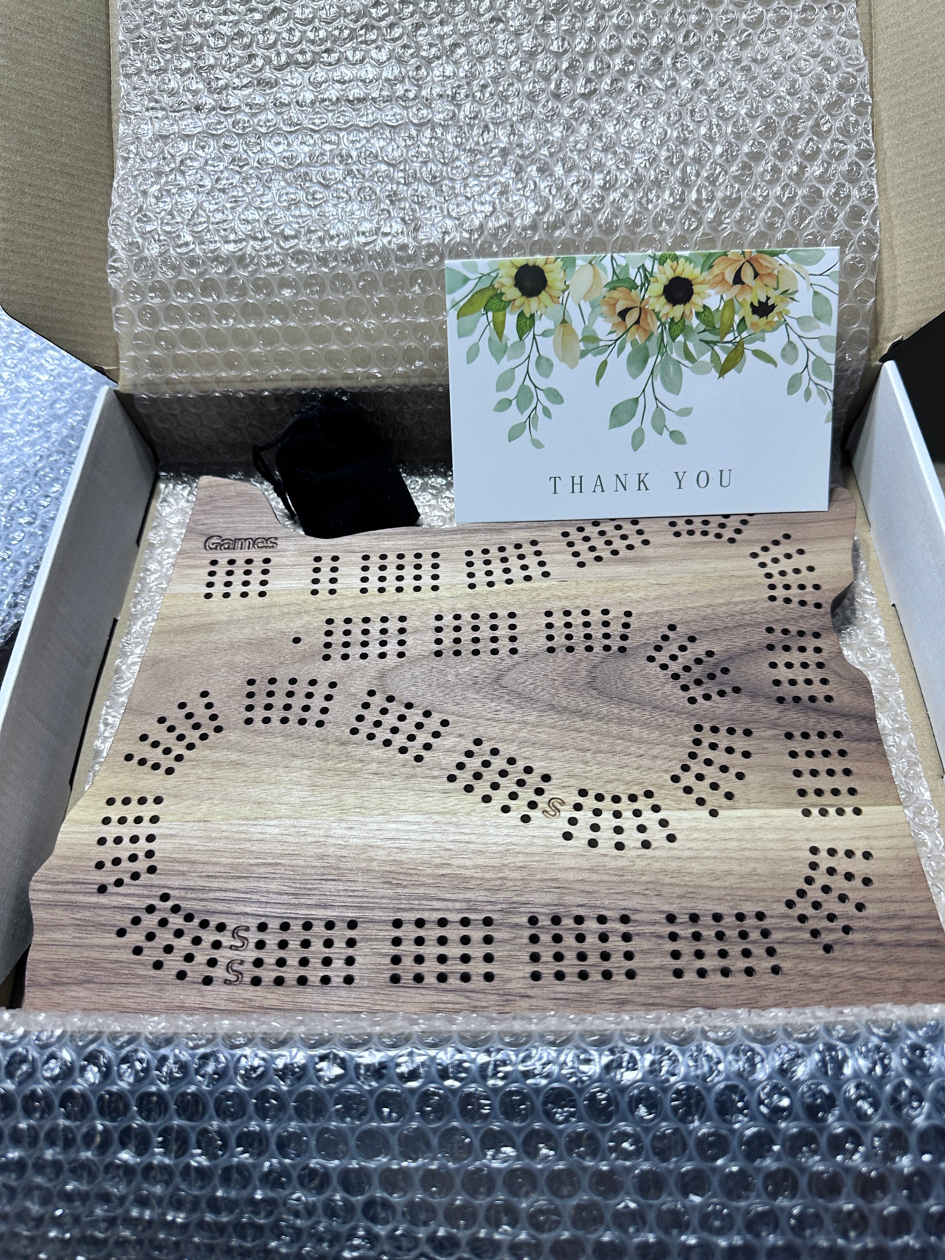 Calico walnut Oregon cribbage board with packaging and a 'Thank You' card.