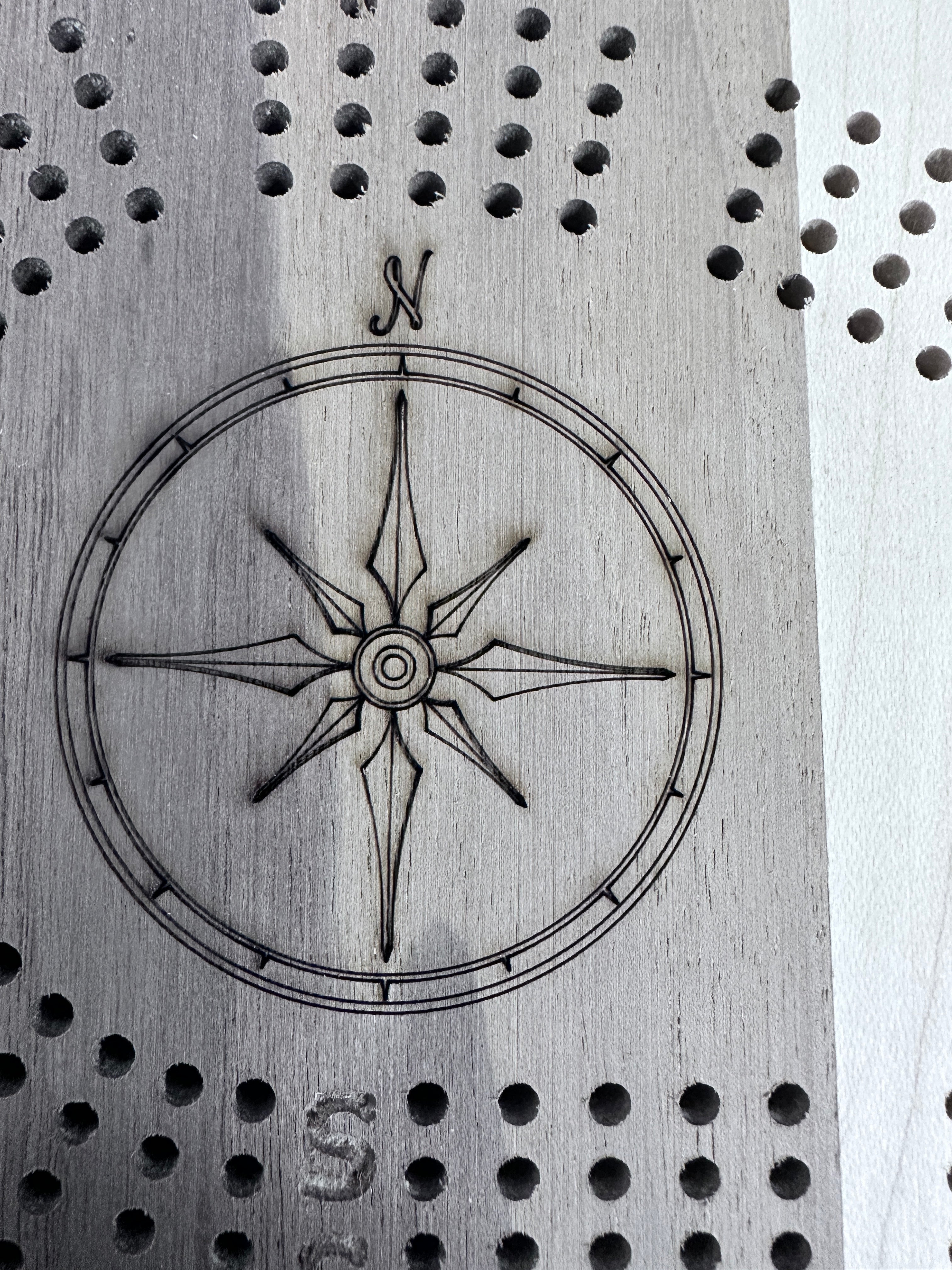 Compass engrave example on light wood 