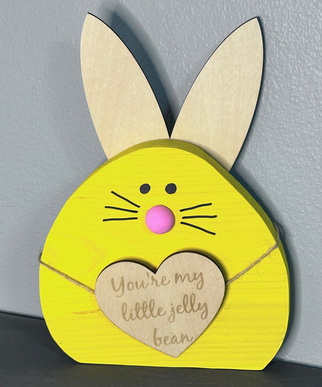 Yellow painted wooden easter bunny head with light wood ears and heart with cute Easter saying