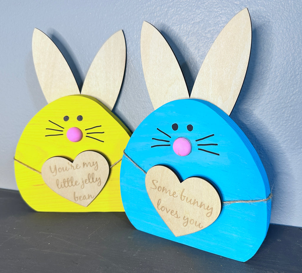 Yellow and Blue painted wooden easter bunny heads with light wood ears and hearts with cute Easter sayings