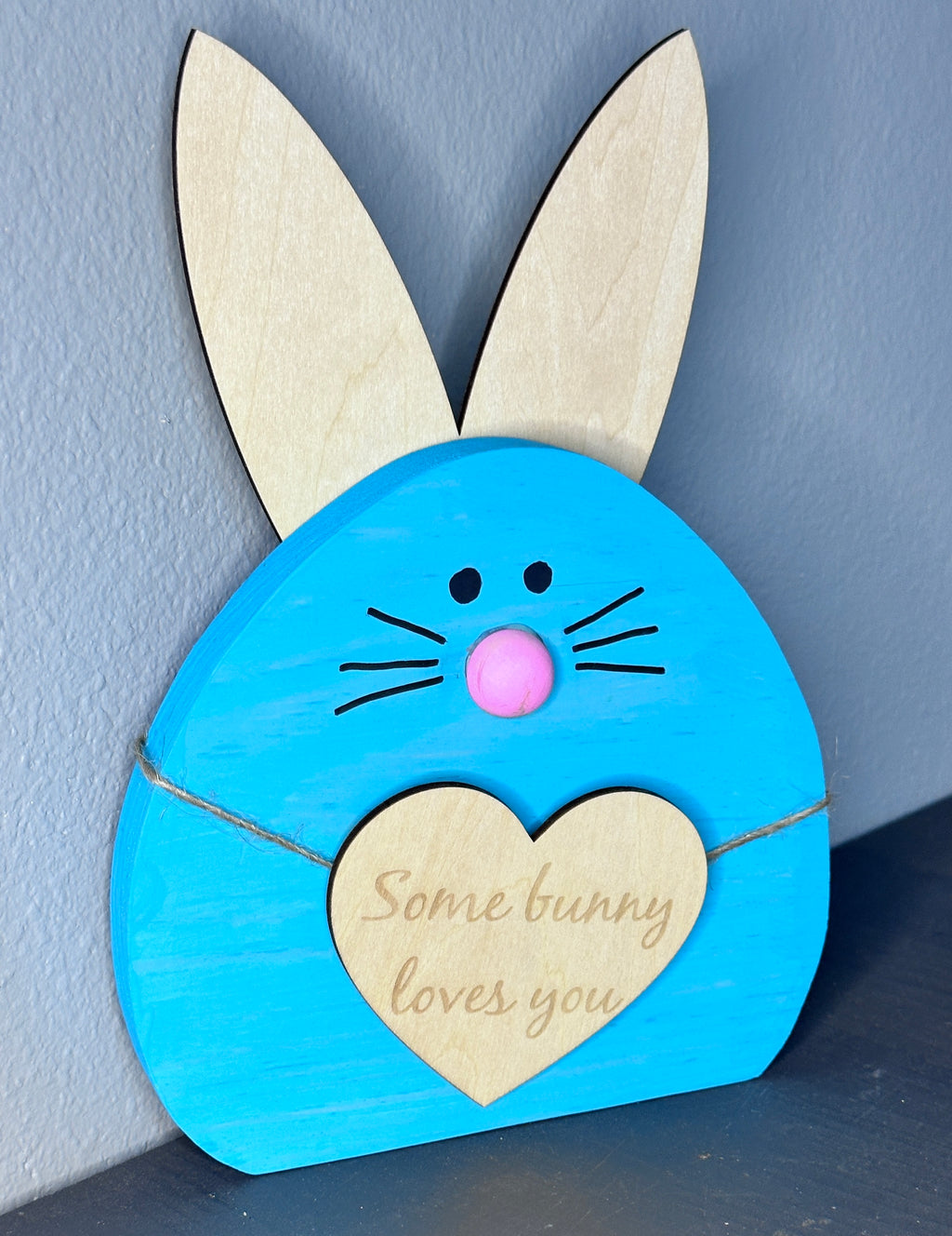 Blue painted wooden easter bunny head with light wood ears and heart with cute Easter saying