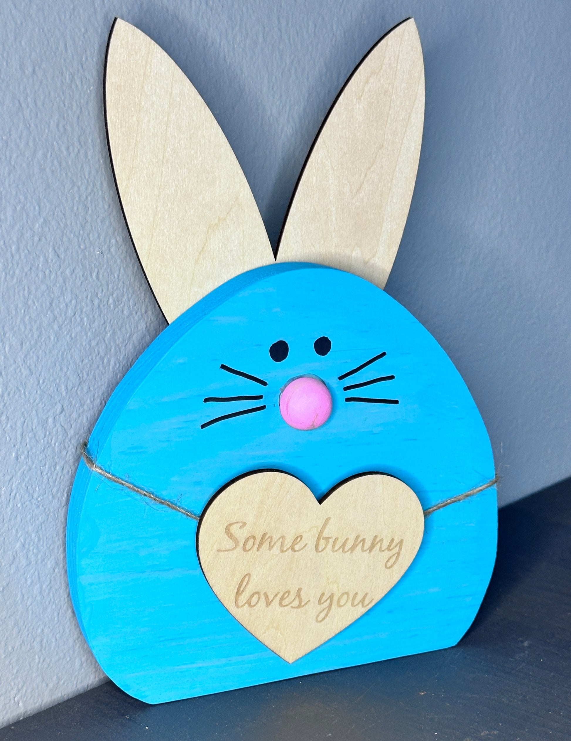 Blue painted wooden easter bunny head with light wood ears and heart with cute Easter saying