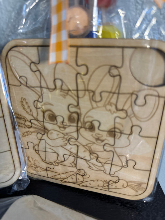 Wooden puzzle 5-inch with paint supplies and ribbons  of cute bunnies pre-packaged clear package with checkered ribbon zoomed in