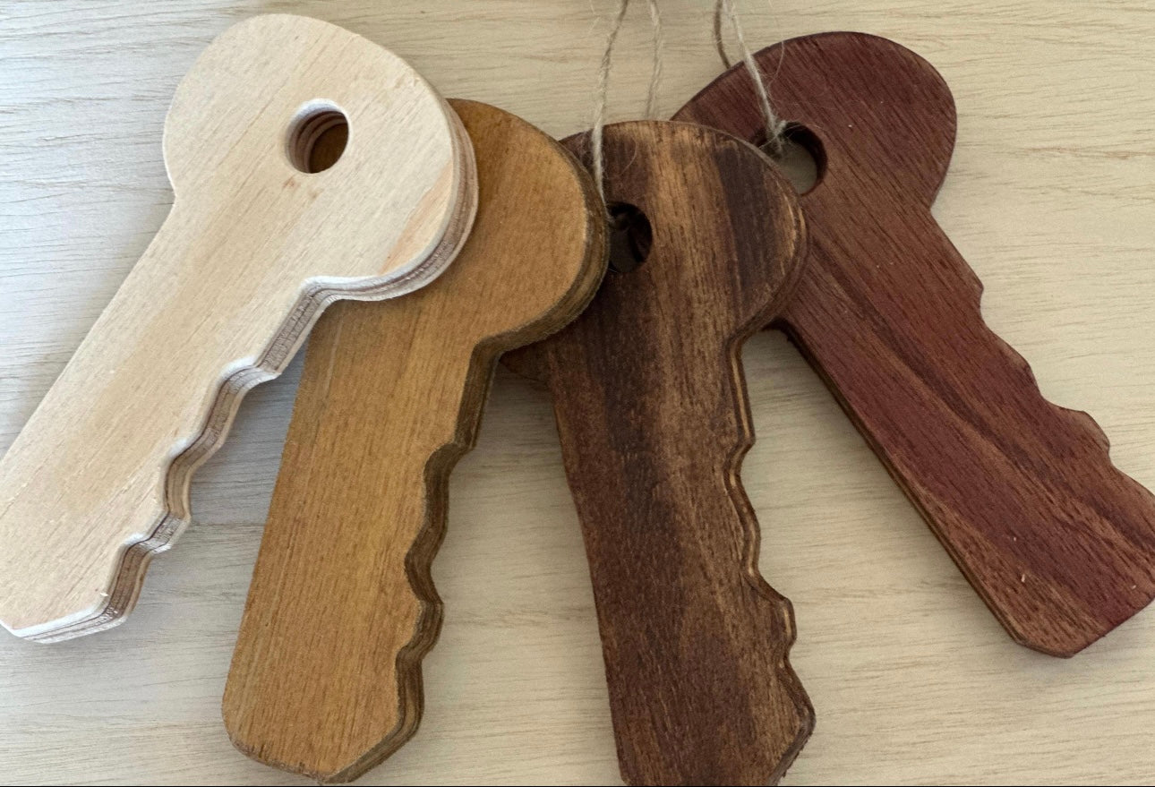 set of 4 wooden keys showing natural wood, light, dark and chestnut stains