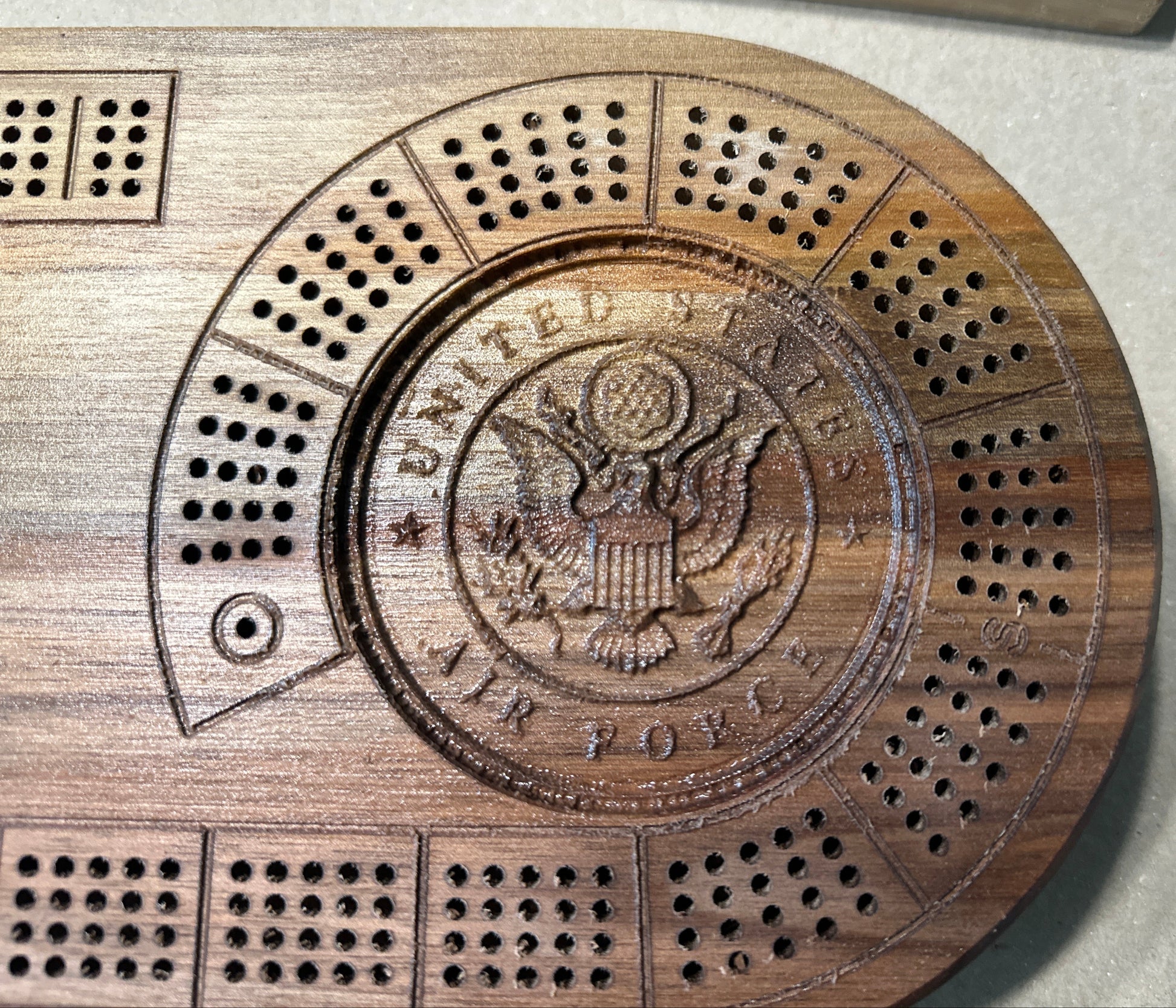 Oval 4 player hardwood cribbage board zoomed in for 3d engraving of Air Force emblem