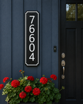 Custom 5-inch vertical address sign with white numbers on black HDPE installed beside a front door