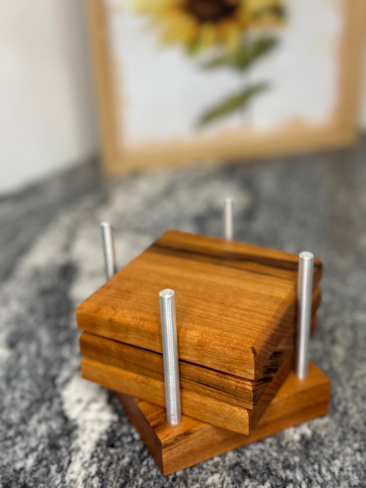 Three Brazill wood coasters displayed in their holder.