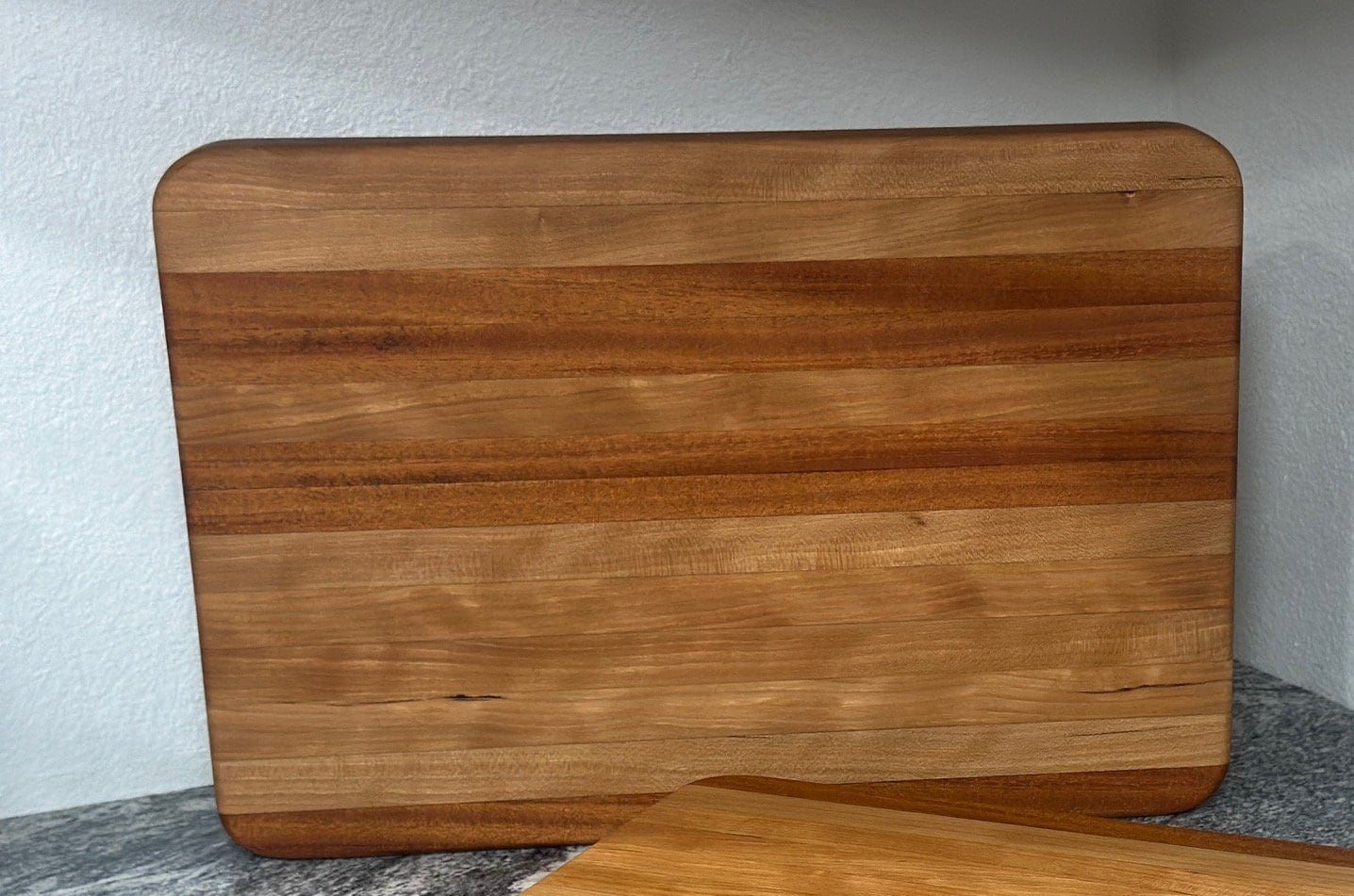 Zoomed in of Mahogany block cutting board with cherry stripe showing unique wood grain
