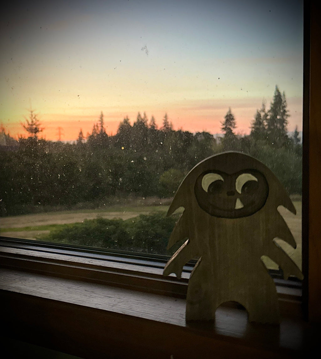 Hardwood Large Bigfoot in blue pine with walnut stain sitting on windowsill with forest setting sun view
