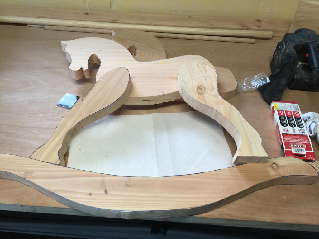 initial lay out of wood pieces for custom made Antique style wooden rocking horse
