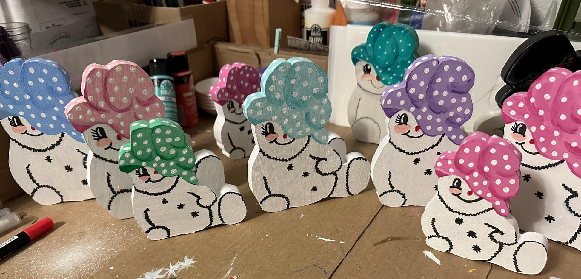 9 Wood painted snow woman shelf sitters with varies colors of painted caps