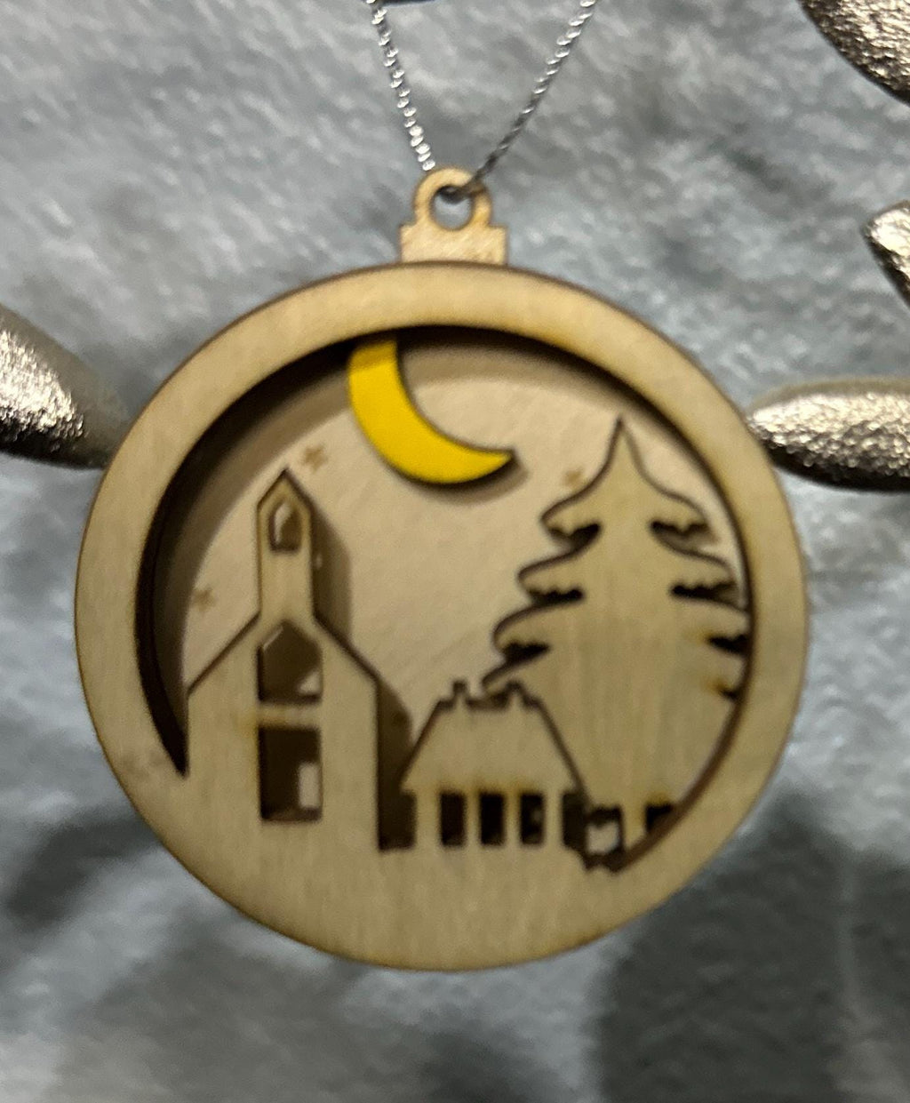 Zoomed in view of church, tree and yellow moon ornament