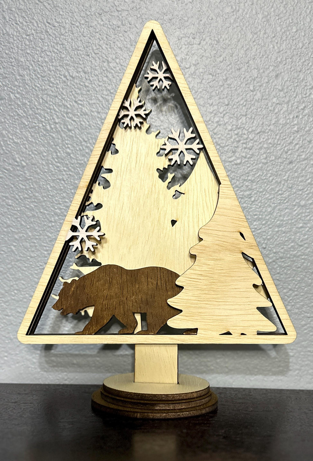 Wood layered triangle decor with stained dark bear with tree and white painted snowflake accents