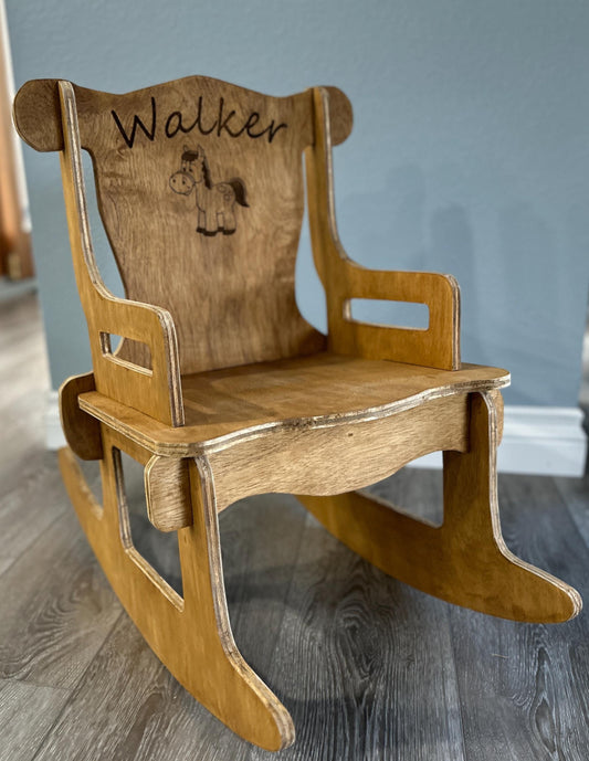 Stained puzzle rocking chair for a toddler with laser engraved name "Walker" and a laser engraved cartoon horse on the chair back.