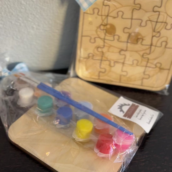 Video of wooden puzzle 5-inch with paint supplies of cute kitten pre-packaged clear wrapping with checkered ribbon