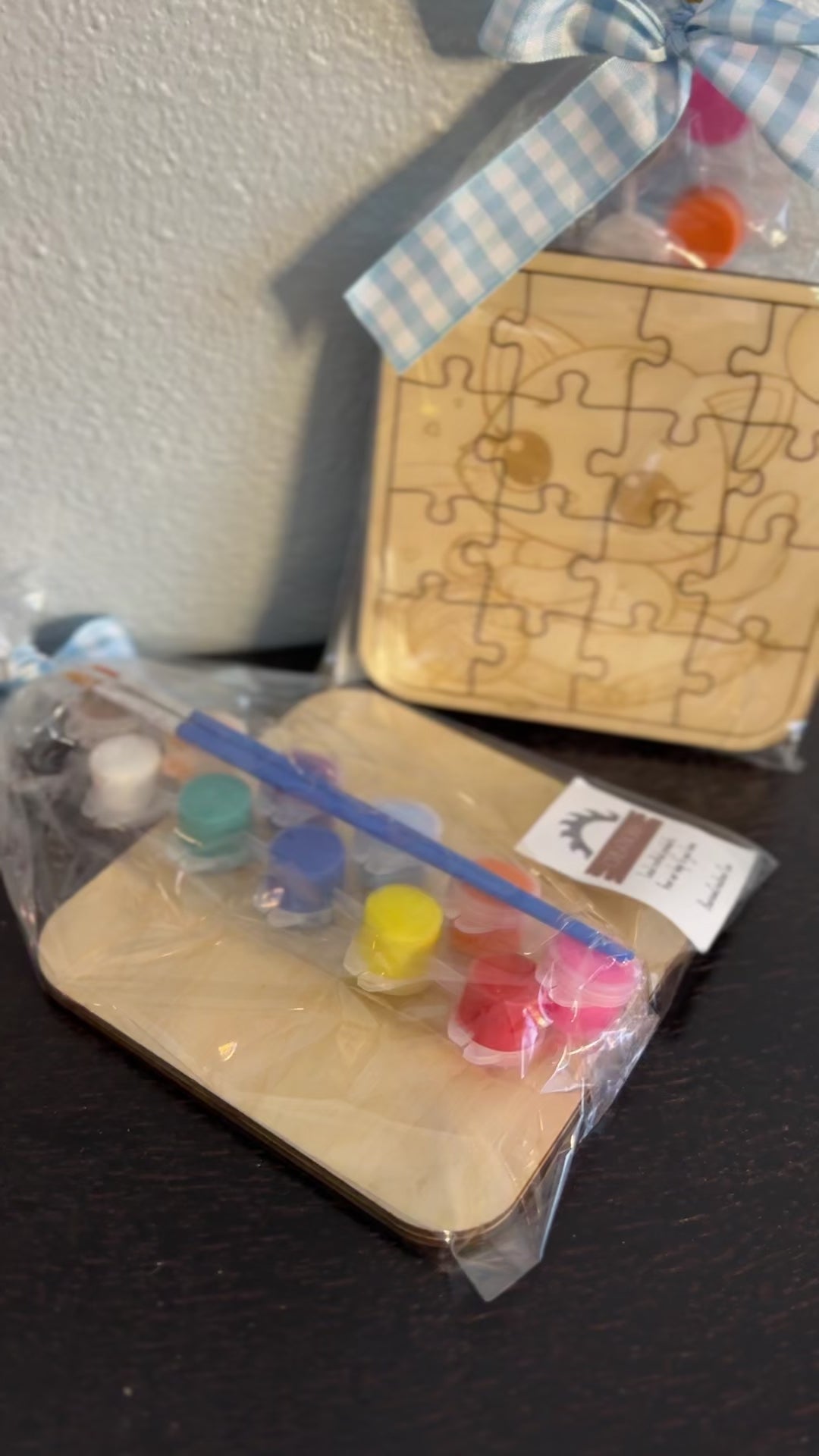 Video of wooden puzzle 5-inch with paint supplies of cute kitten pre-packaged clear wrapping with checkered ribbon